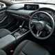 Mazda 3 (2023) review: dashboard and steering wheel, black upholstery