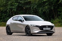 Mazda 3 (2023) review: front three quarter static, silver paint, trees in background