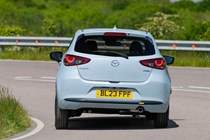 Mazda 2 (2023) review: rear cornering, showing body roll, blue paint, British country road