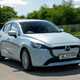 Mazda 2 (2023) review: front three quarter driving, blue paint, British country road