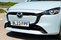 Mazda 2 (2023) review: radiator grille detail, showing yellow accent on bumper, blue paint