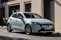 Mazda 2 (2023) review: front three quarter static, blue paint, urban background