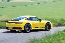 Porsche 911 review (992) - Carrera T, yellow, rear, driving round corner