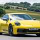 Porsche 911 review (992) - Carrera T, yellow, front, driving round corner
