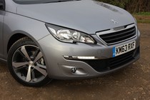 Peugeot 308 Hatchback (2014-) UK rhd model in metallic silver. Exterior detail - front right wheel arch, wheel and braking components