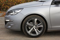 Peugeot 308 Hatchback (2014-) UK rhd model in metallic silver. Exterior detail - front left wheel arch, wheel and braking components