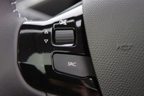 Peugeot 308 Hatchback (2014-) UK rhd model in metallic silver. Interior detail - steering wheel volume control