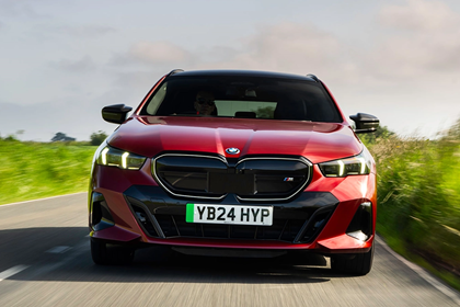 BMW i5 Touring Deal Watch, front shot, driving, red, Deal Watch | Parkers