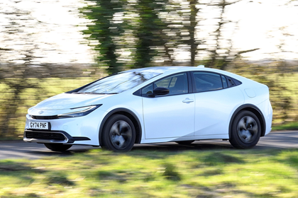 Toyota Prius, white, exterior front three-quarters, driving | Parkers