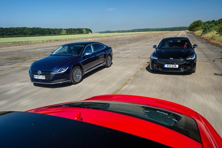 Kia Stinger Vs Audi A5 Sportback Vw Arteon Parkers Kia Stinger Vs Audi A5 Coupe Vw Arteon Driving Shot