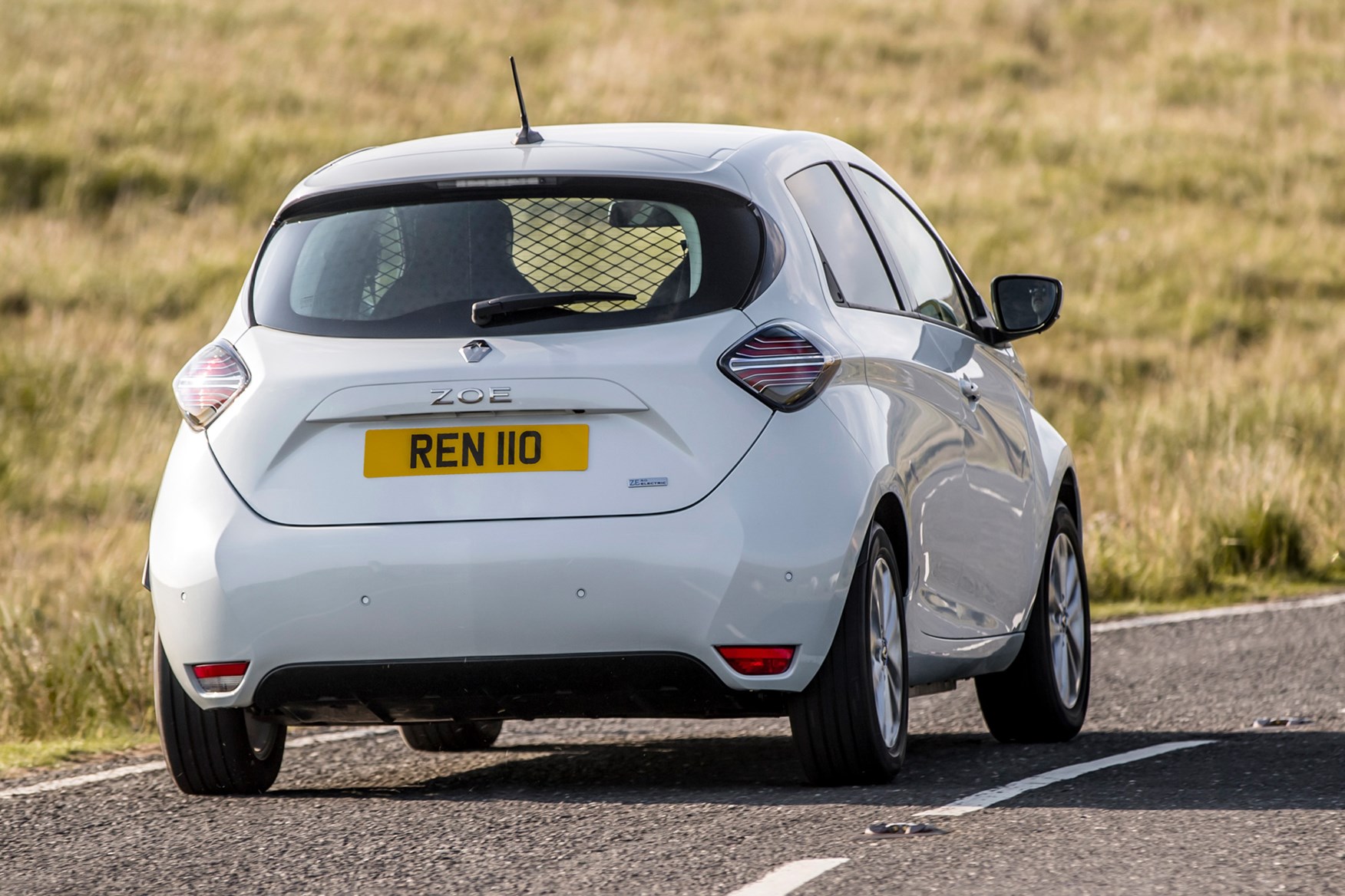 Renault Zoe Van review, 2020, rear view, white, driving round corner