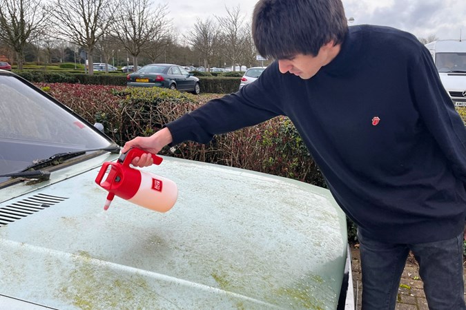 Aaron Hussain sprays ValetPRO from a pump sprayer