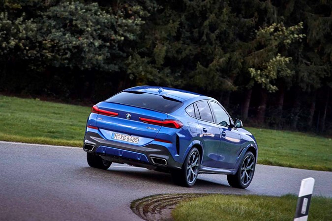 2019 BMW X6 driving rear three quarters blue