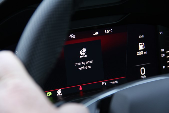Close up of cluster display of Skoda Karoq through the steering wheel, showing heated wheel on
