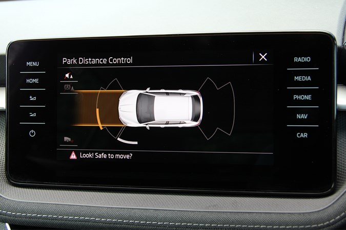 A close up shot of the centre display showing which parking sensors are triggered by the environment i.e. where is the obstacle detected?