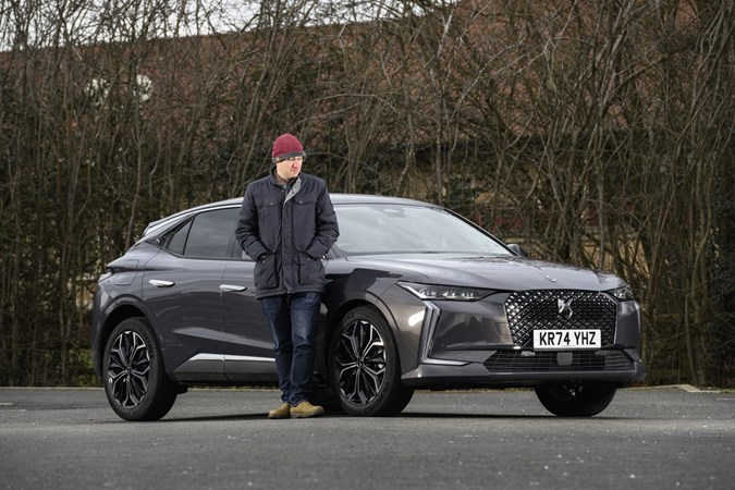 Image of a grey DS 4, from the front right three-quarters, writer Graham King stood alongside