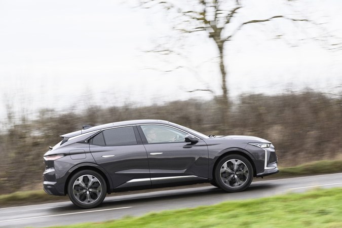 Image of a grey DS 4 driving, viewed in profile from the right-hand side