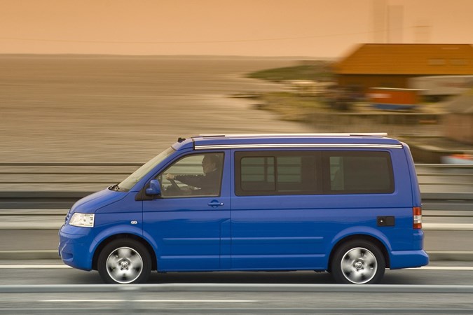 Image of Volkswagen California T5, in blue, driving, from left side