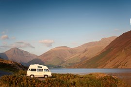 Campervan parked next to lake in Lake District