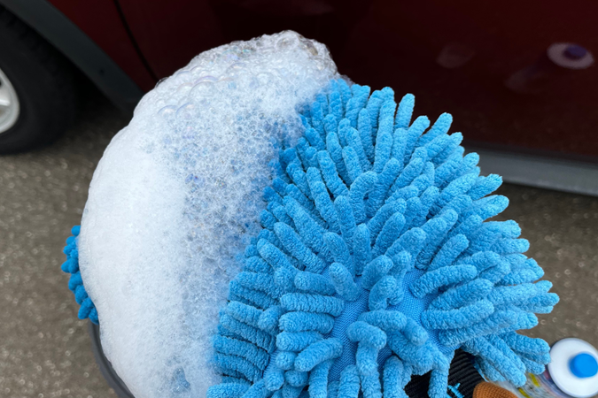 The foam from the shampoo on a wash mitt