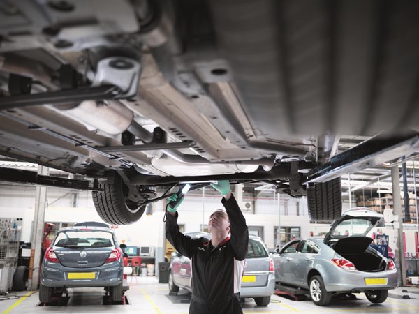 Mechanic checking under car - What is an MOT
