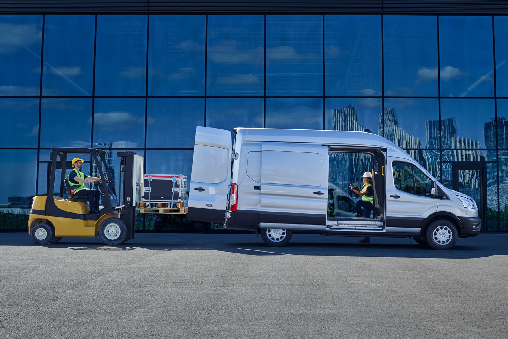 Ford E-Transit review - side view, being loaded by forklift