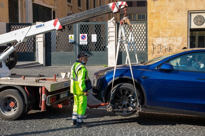 Illegally parked car being towed in Italy