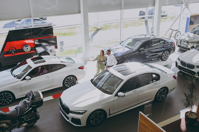 Couple browsing car showroom