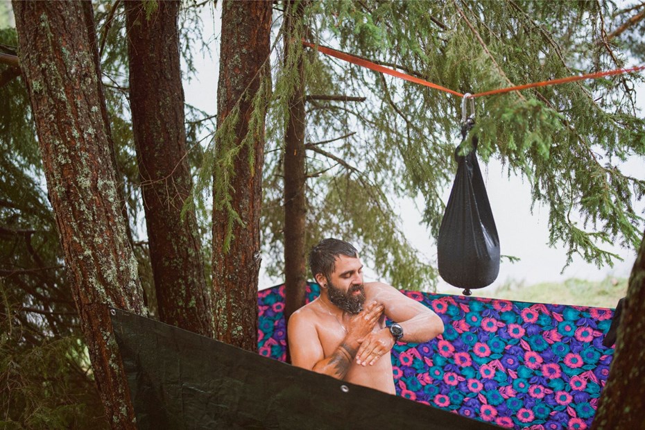 Man using a portable camping showers