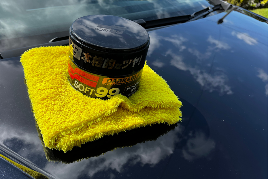 Soft99 wax resting on a car bonnet