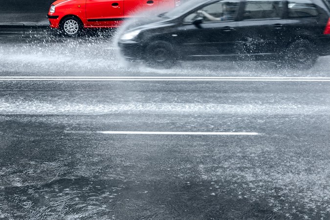 Image of cars driving in very heavy rain