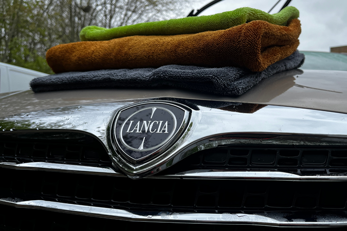 Three drying towels resting on a Lancia's bonnet