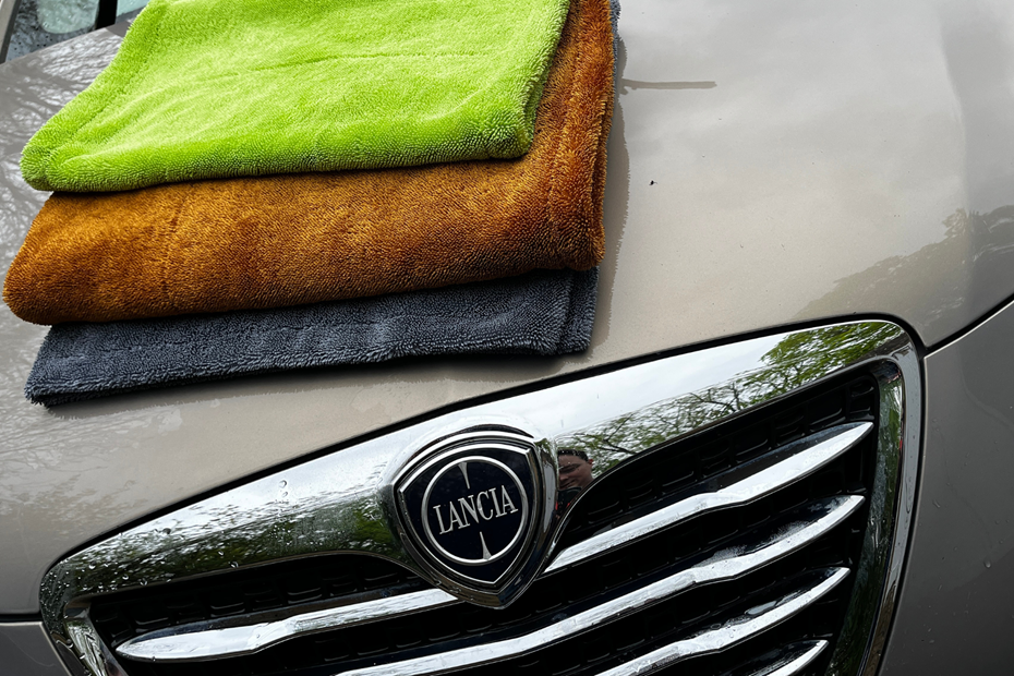 The three drying towels on a car bonnet