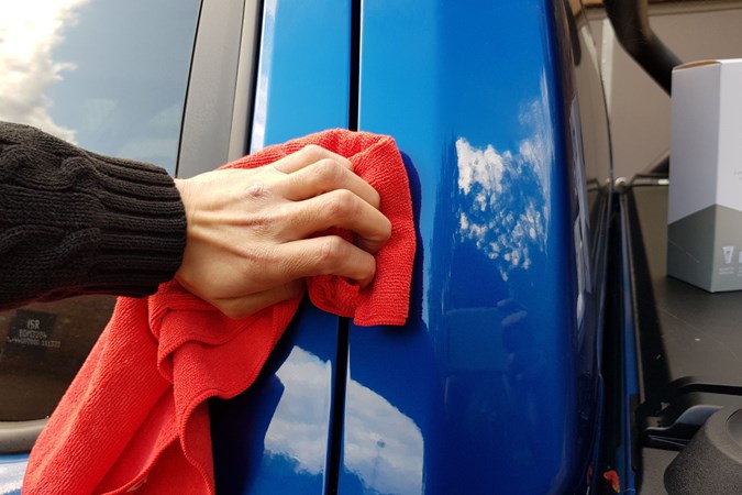 Aaron Hussain buffing the scratch area on a VW Amarok