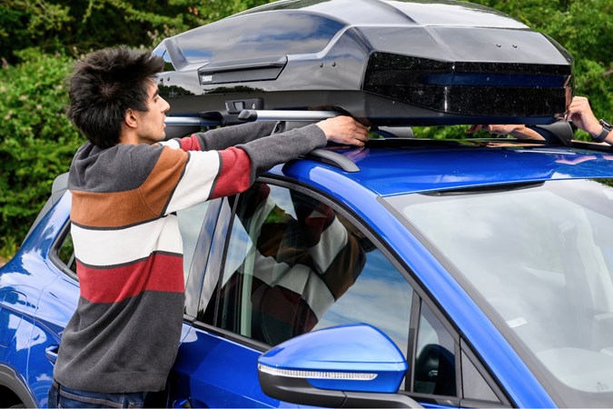 Aaron Hussain fitting a roof box to a Skoda Elroq