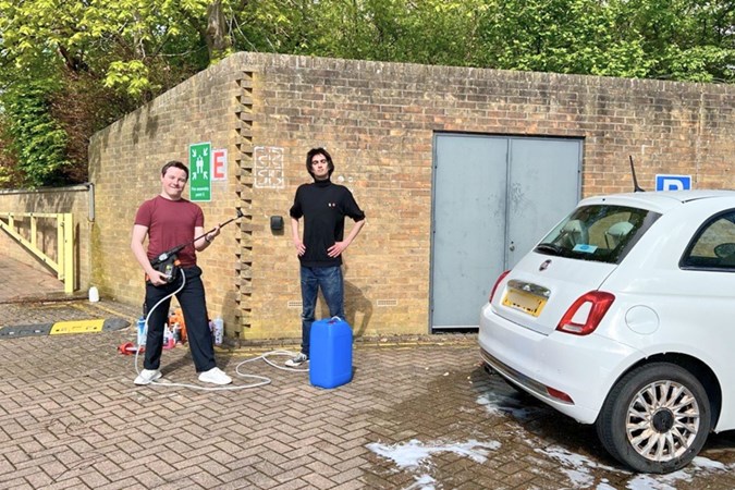 Ryan Gilmore and Aaron Hussain pose before cleaning a car