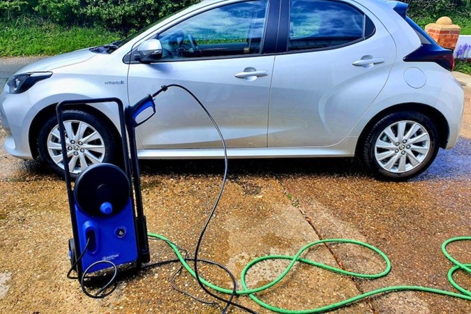 The Nilfisk 140 pressure washer on test next to a silver car