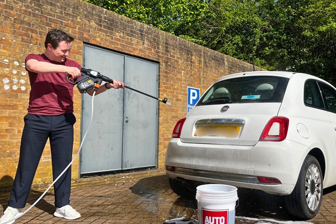 Ryan Gilmore cleans a white car with the Worx Nitro