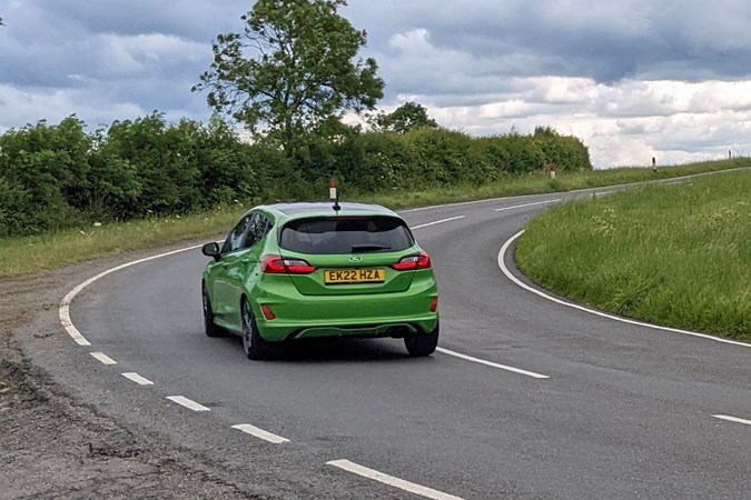Ford Fiesta ST review, rear view, 2022 facelift, Mean Green, driving round corner