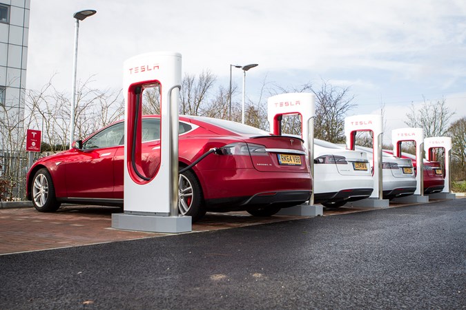 Red Tesla at Tesla supercharger location 