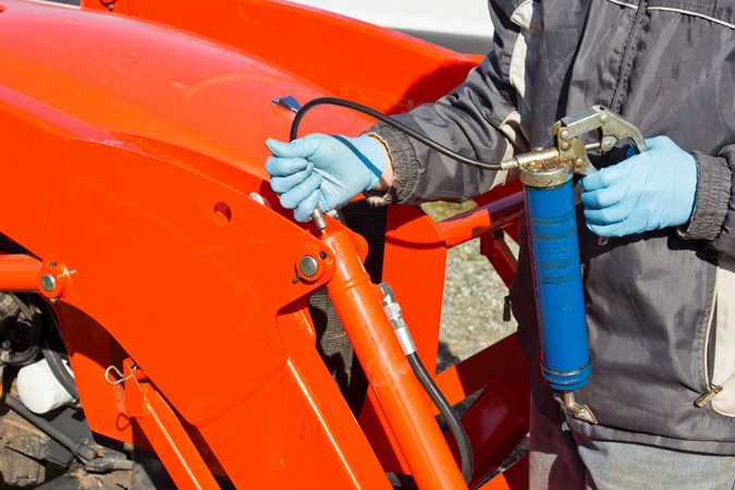 A grease gun in use