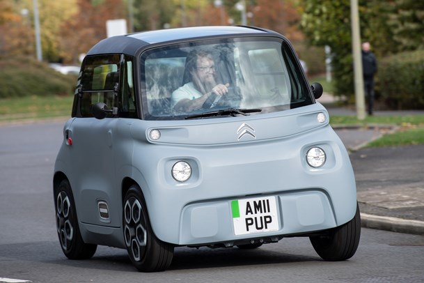 Citroen Ami (2022) review: front three quarter cornering shot, grey car, showing body roll