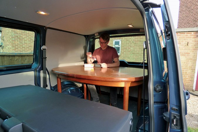 VW Transporter T6 TSI long-term test review - Chris Lloyd eating at the dining room table in the back