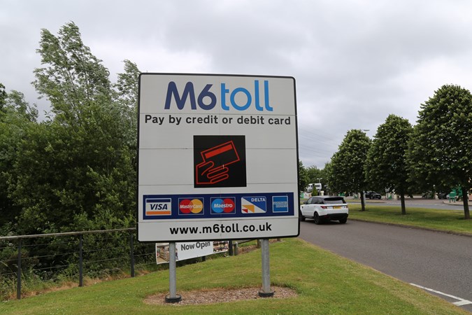 Road sign denoting types of payment accepted on M6 Toll road
