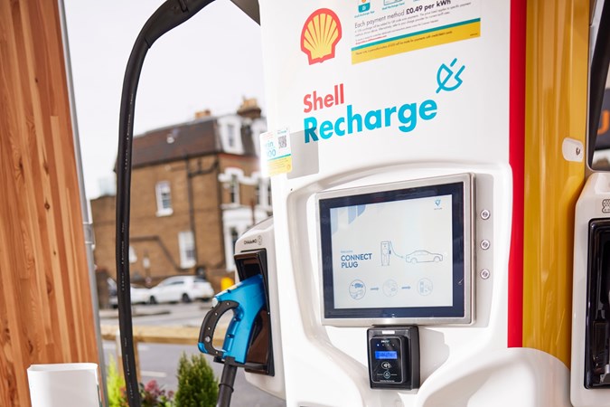 Close up of a Shell Recharge charge point with display and plug-in connector