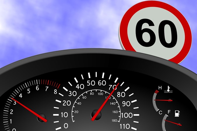 Graphic denoting driver instrument cluster with speedo, rev counter against a cloudy blue sky and 60mph sign in background