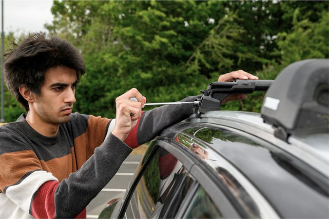 Aaron Hussain bolting the Thule WingBar Edge in place