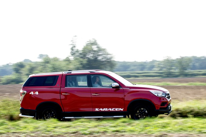 SsangYong Musso driving, panning, red