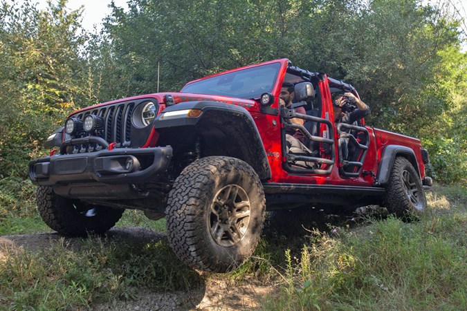 2019 Jeep Gladiator review - red, tube doors, front view driving off-road over bumps