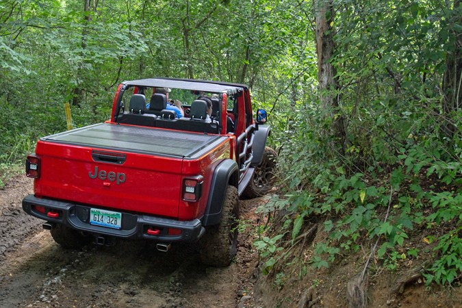 Jeep Gladiator review - red, driving around tight muddy corner, off-road